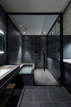 a bathroom with two sinks and a large mirror on the wall next to the bathtub