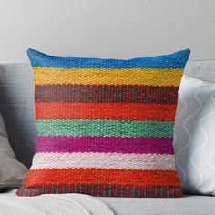 a multicolored pillow sitting on top of a couch