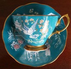 a tea cup and saucer on a wooden table