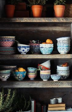 several bowls and plates on shelves in a room