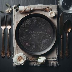 a place setting with silverware and flowers