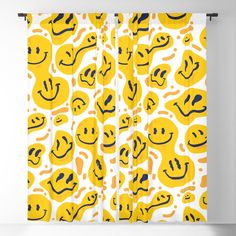 a yellow curtain with smiley faces on it