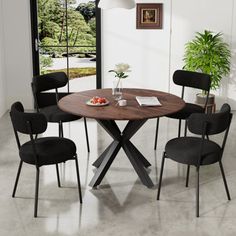 a dining table with four chairs around it