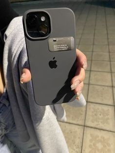 a woman holding up an iphone in her hand