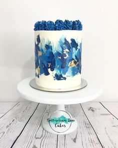 a white cake with blue flowers on it