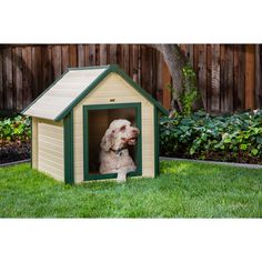 a dog is sitting in a small house shaped like it's own pethouse