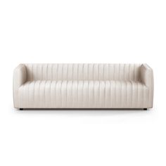 a white couch sitting on top of a white floor