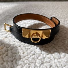 Hermes Rivale Double Tour Bracelet. Black Leather With Gold Hardware. New! Stickers All Intact. Never Worn. Size T2. Approx 13” L Not Including Buckle. Or Approx 13.5” L Including Buckle. Comes With Box And Pouch. 100% Auth. Poshmark Will Authenticate Items $500 And Up. I Will Not Go Any Lower Than $500 Since I Want This To Go Through The Authentication Process With Poshmark. Safer That Way. Thank You For Your Understanding. Hermes Bracelet, Hermes Jewelry, Bracelet Black, Womens Jewelry Bracelets, That Way, Bracelets For Men, Gold Hardware, Leather Bracelet, Black Leather