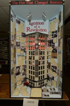 a display case in the shape of a building with information about its history and locations