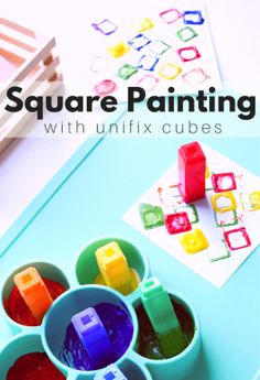 an image of square painting with unfix cubes on the table in front of it