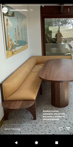 a wooden bench sitting next to a table on top of a tiled floor in front of a window