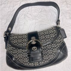 Coach Signature Sufflette Leather Handbag Very Good Condition Black, Leather A Rare Vintage Piece For Coach Enthusiasts! This Is A Coach Vintage Black Signature Iconic Signature Jacquard Fabric & Leather Soho Hobo Buckle Purse With No Call Outs And In Aaa+ Condition. Top Handle Hobo Bag With Branded Hardware, Hobo Bag With Branded Hardware And Top Handle, Coach Hobo Shoulder Bag With Branded Hardware, Coach Shoulder Bag With Silver-tone Hardware, Chic Black Hobo Bag With Silver-tone Hardware, Classic Coach Hobo Bag With Silver-tone Hardware, Elegant Coach Hobo Bag With Branded Hardware, Chic Coach Satchel With Silver-tone Hardware, Elegant Coach Hobo Bag With Silver-tone Hardware