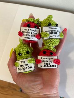 three little crocheted frog finger puppets with i love you to - ma - toee written on them