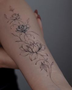 a woman with a flower tattoo on her arm