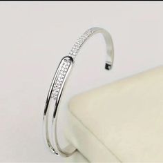 Silver Tone Metal Bracelet With Rhinestones Adjustable Diamond-accent Cuff Bangle, Adjustable Bangle Cuff Bracelet With Diamond Accents, Adjustable Diamond Accented Cuff Bangle, Adjustable Metal Cuff Bracelet With Rhinestones, Silver Adjustable Cuff Bracelet With Rhinestones, Adjustable Silver Cuff Bracelet With Rhinestones, Adjustable Silver Cuff Bracelet With Diamond Accents, Adjustable Crystal Cuff Bracelet In Bangle Shape, Adjustable Crystal Cuff Bangle Bracelet