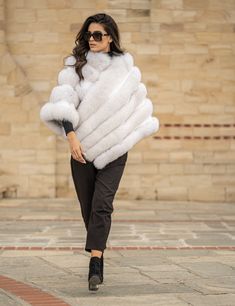 Amazing fluffy fox fur poncho in a great natural white color. A modern but also diachronic design, that can be worn in every occasion, giving style and elegance to your outfit. An ideal piece, for those who want to spoil themselves! Fluffy fox fur poncho Diagonal zipper closure Without pockets Without sleeves style In natural white color Stunning color The fur is dense ,glossy ,plush and luxuriously soft High quality lining Length 70cm The size of the poncho on the photo is One Size Finest quali Fur Poncho, Poncho Coat, Fur Cape, Real Fur Coat, Luxury Gifts For Her, Ladies Poncho, Elegant Hats, Mink Fur Coat, Cold Weather Fashion