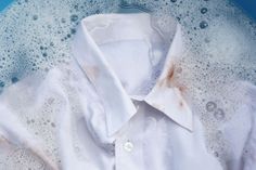 a white shirt that has been washed and is sitting in some water with bubbles on it