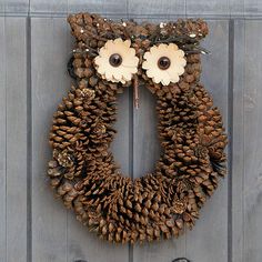 a wreath made out of pine cones and flowers on a wooden door with the number four