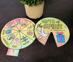 two fan shaped cards with gifts of the spirit written on them next to a potted plant