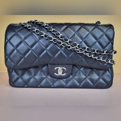 Preowned Chanel Classic Black/Burgundy Double Flap Lambskin Quilted Chain Strap Shoulder Bag. This Bag Can Be Also Worn Crossbody. Size: Large/Jumbo. Measurements: 12"W/8"H/3.5"D Condition: Please Note This Bag Has Moderate Signs Of Wear Which Includes Scuffing, Indentations, Creasing, And Discoloration. We Are A Reseller. We Do Not Possess Any Information Of The History Of The Bag. We Do Not Know If The Bag Was Repaired Or Repainted. It Does Not Seem So To The Naked Eye. Exterior: There Are Scu Flap Shoulder Bag, Shoulder Bag Black, Chain Strap, Chanel Bag, Chanel Classic, The History, Classic Black, Chanel, Bag Lady