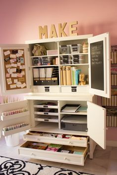 a white desk with lots of drawers and files