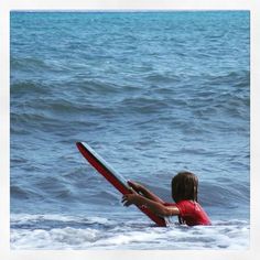 a person in the water with a boogie board