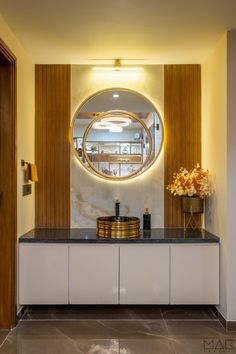 a bathroom with a round mirror on the wall and marble counter top in front of it