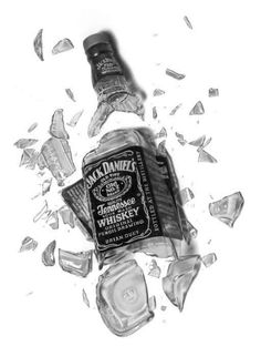 a bottle of jack daniels whiskey surrounded by broken glass shards and ice cubes on a white background