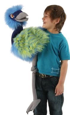 a young boy holding a stuffed animal in his hands