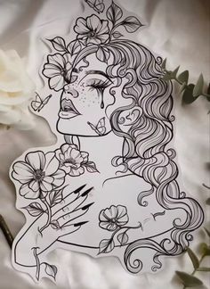 a drawing of a woman with flowers in her hair and butterflies on her face, surrounded by white roses