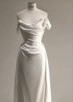 a white dress on display in a museum