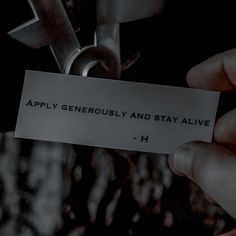 a person holding a piece of paper with the words apply generous and stay alive