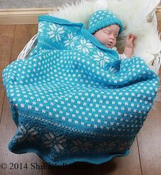 a baby wrapped up in a blue blanket