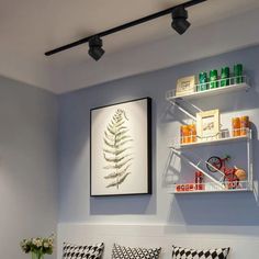 a living room filled with lots of furniture next to a wall mounted art piece on the wall