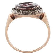 Our Antique Minerva Intaglio Ring is incredibly rare and rich in history. The hand-carved intaglio is made of rhodolite garnet and depicts Minerva the goddess with a halo of diamonds. The intaglio hails from the 17th century, while the ring is Georgian from the late 1770s to 1830. The surrounding diamonds are silver set with gold underneath. Take extra care when wearing this ring, we advise to not get it wet. This ring cannot be resized. Stones: Rhodolite Garnet, DiamondsMetal: 14/15k Yellow Gol Antique Ruby Signet Ring, Byzantine Intaglio Ring For Anniversary, Victorian Intaglio Engraved Ring, Intaglio Ring, Vintage Jewelry Antique, Rhodolite Garnet, The Goddess, Antique Rings, 17th Century