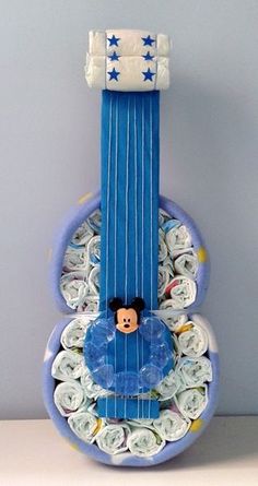 a musical instrument made out of rolled up baby's diapers with mickey mouse on it