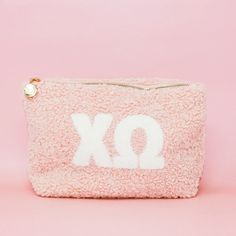 Carry around all your must-haves in style with this Sorority Letter Teddy Pouch! Perfect for throwing into a bag or toting around separately, this cute lil' pouch is made of soft sherpa material and features a gold zipper detail with a retro floral interi Big/little Baskets, Sorority Letters, Sorority Big Little, Patriotic Fashion, Gamma Phi Beta, Clothing Gifts, Elegant Baby, Keychain Wallet, For Her Gifts