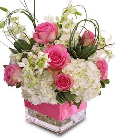 pink roses and white flowers in a square vase