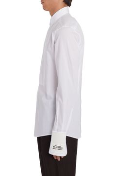 From the label's 'Re-Edition' collection comes this cotton-poplin shirt that features a partially hidden placket and a tuxedo-style bib. 31" length; 38" chest (size Medium) Front button closure Point collar Long sleeves with two-button cuffs 100% cotton Dry clean Made in Italy Men's Designer Clothing Designer White Shirt With Concealed Placket, Designer Cotton Top For Formal Occasions, Elegant Long Sleeve Poplin Shirt, Elegant Poplin Shirt With Button Cuffs, Elegant Poplin Shirt For Spring, Elegant Spring Poplin Shirt, Classic Dress Shirt With Concealed Placket For Daywear, Elegant White Poplin Shirt, Luxury White Shirt With Concealed Placket