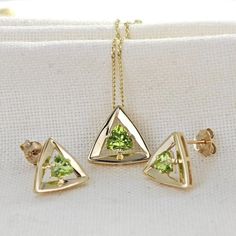 Elegant 9ct Gold peridot pendant and stud earring set. Ojewellery design and part of our first full gold collection. Produced in very small quantities you will only find this set from Ojewellery direct. Trillion cut peridot set in a raised triangle made of solid yellow gold. The design lifts the stone to allow light to filter to its back and show the stone of with an elegant sparkle. The natural green peridot is from Arizona USA. The stones measure 5 x 5mm in the pendant and 4 x 4mm in each stud Fine Jewelry With Peridot And Matching Earrings, Gift Yellow Gold Diamond Cut Jewelry Sets, Yellow Gold Polished Peridot Jewelry, Yellow Gold Peridot Jewelry With Polished Finish, Gold Peridot Jewelry With Polished Finish, Uk Design, Peridot Pendant, Peridot Necklace, Elegant Pendant