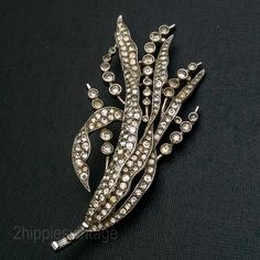 Enormous 1940s Alfred Spaney Design for Trifari Rhinestone Brooch Pin  | Marked DES Pat Pend 129321.   Condition: Excellent vintage condition.  Actual pin is bent a bit.   Some stones less sparkly than others. Approximate Measurements: 2 5/8" x 3/4" wide. We sell select vintage items. They are not new, and rarely look new. They are, in many cases, older than we are.  They have seen life and times. We do not repair or replace parts on any of the items we sell.  They came to us in the condition th Vintage Rhinestone Brooches For Vintage Events, Antique Rhinestones Brooch For Vintage Events, Antique Rhinestone Brooches For Vintage Events, Antique Rhinestone Brooches For Anniversary, Vintage Rhinestone Brooches For Evening, Vintage Evening Brooches With Rhinestones, Antique Jeweled Brooch For Wedding, Vintage Silver Brooch With Rose Cut Diamonds, Vintage Silver Brooches With Rose Cut Diamonds