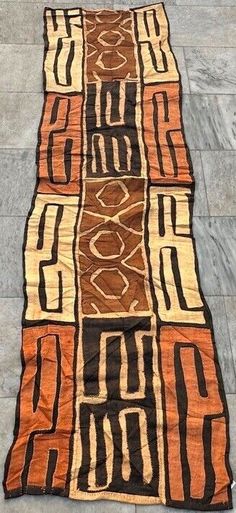 an orange and black rug on the ground