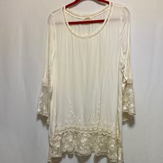 Tunic In Excellent Condition. Cream Colored. Long Sleeves. Size Large. Beautiful Lace Embellishment Through Out. 100% Rayon 100% Nylon Trim Hand Wash. Pit To Pit: 21” Sleeve: 23” Neck To Hem: 31” Bohemian Stretch Lace Top, Fitted Bohemian Top With Lace Sleeves, Bohemian Spring Stretch Lace Top, Bohemian Stretch Lace Top For Spring, Fitted Off White Bohemian Tops, Fitted Off White Lace Top For Summer, Cream Stretch Blouse For Summer, Fitted Off-white Lace Top For Spring, Fitted Off White Lace Top For Spring