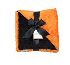 an orange and black blanket with a bow on it