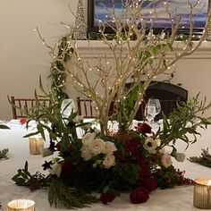 the table is set up with candles and flowers for an elegant centerpieces display