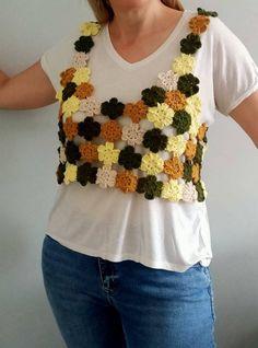 a woman wearing a crocheted flowered top