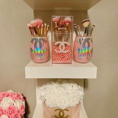 there are two cakes on the shelf and one is decorated with pink, white roses