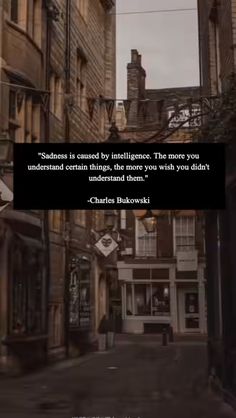 a city street with buildings and a quote from charles burowski on the image