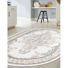 a white rug with an ornate design on the floor