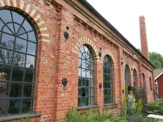 an old red brick building with arched windows